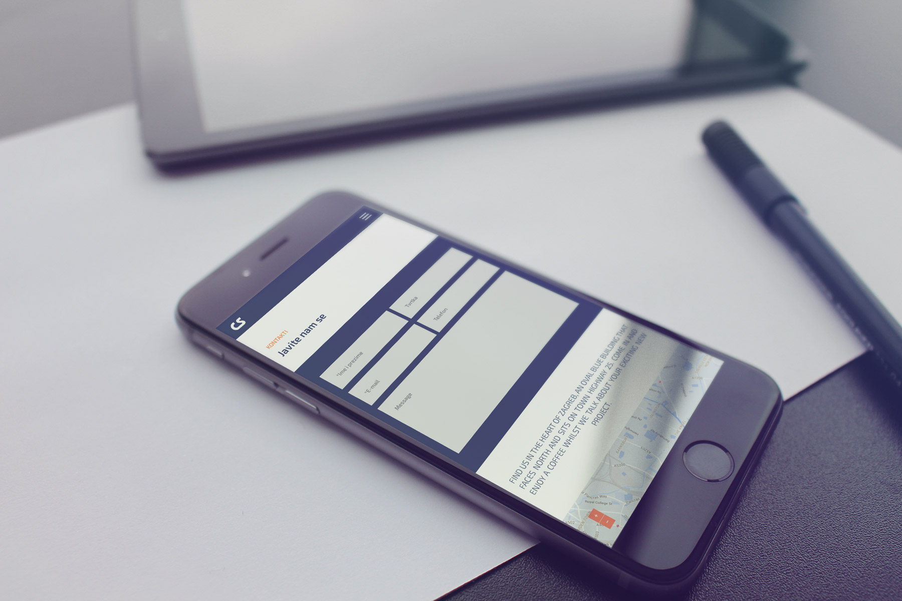 Smartphone on a table showing contact page