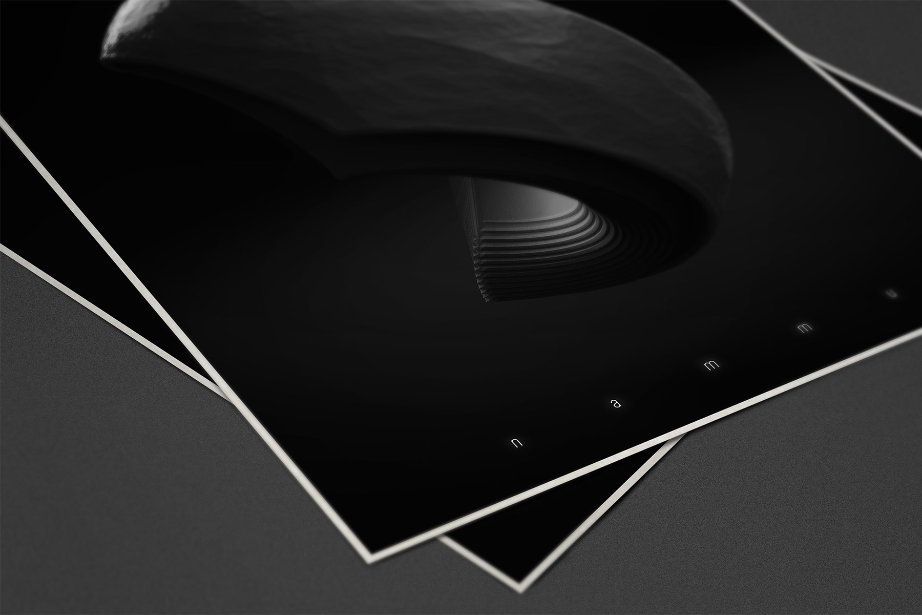 Two Metaphorm 3D artwork posters on a dark surface over each other